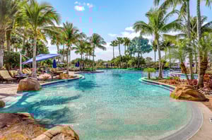 This condo community swimming pool has boulder features and fountains.