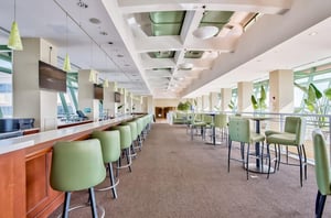 A bar and dining tables in the onsite restaurant at Emerald Beach Resort