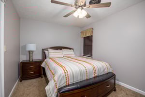 Bedroom With Bedside Table at Hoop Dreams Lodge