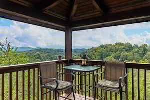 Deck table and chairs for two at Eagles Nest, a 2bedroom cabin rental located in Sevierville