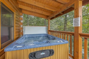 Hot tub on a covered deck at Cubs Crossing, a 3 bedroom cabin rental located in Gatlinburg
