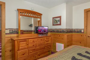 Dresser, mirror, and TV in a bedroom at Cubs Crossing, a 3 bedroom cabin rental located in Gatlinburg