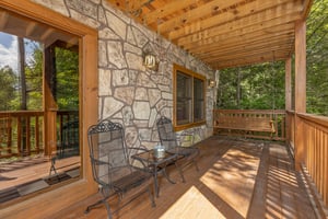 Lower deck seating and swing at Cubs Crossing, a 3 bedroom cabin rental located in Gatlinburg