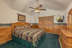 Bedroom with a queen bed, TV, and dresser at Cubs Crossing, a 3 bedroom cabin rental located in Gatlinburg