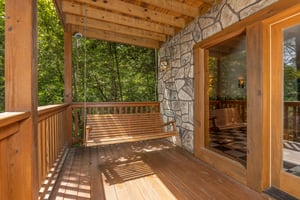 Porch swing at Cubs Crossing, a 3 bedroom cabin rental located in Gatlinburg