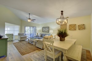 From breakfast to movie night, this openconcept living and dining space at 406 Harbour Oaks offers natural light, high ceilings, and a breezy layout that leads to the screened porch.