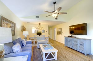 Enjoy movie nights or a quiet afternoon in the openplan living space at 406 Harbour Oaks, featuring a large smart TV and easy flow into the dining area.