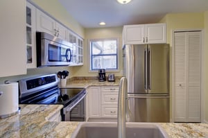 Cook with ease in this wellstocked kitchen at 406 Harbour Oaks, featuring granite countertops, stainless steel appliances, and everything you need for island meals in.