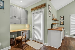 Builtin cabinetry, a dedicated desk, and enough workspace to take the call without leaving the house.