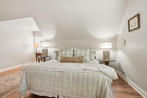 The angled ceiling creates an architectural moment in the primary — spacious and well above the average vacation rental bedroom.