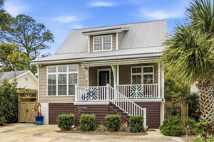 A treelined approach to the home with generous yard space and natural shade canopy.