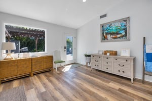 View from the main house living room at 530 Delegal showing interior space with wood flooring and doors opening toward the courtyard.