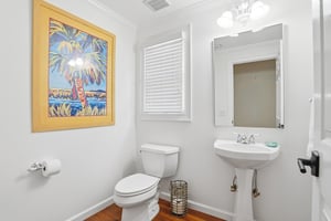Convenient main level half bath located off the hallway near the shared living spaces.