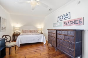 Spacious upstairs bedroom with one king bed and two twin beds, plus its own ensuite bathroom.