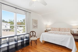 Alternate view of the upstairs kingandtwotwin bedroom with window light and open floor space.