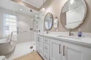The complete bath gives the mainfloor king suite two sinks, a freestanding tub and a glass walkin shower.