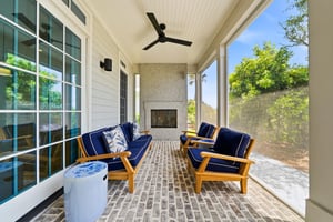 Deep seating and the fireplace create a substantial outdoor living room beside the dunes.