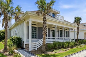 A second exterior angle captures the broad covered porch and landscaped approach in Seaside Retreat.