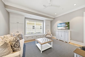 A second livingroom angle highlights the window seat, storage and easy connection to the dining area.