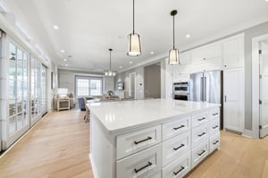 This angle shows kitchen storage, double ovens and the connection to the dining and living areas.