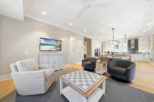 The open layout lets guests move easily between conversation, meals and the screened porch.