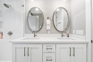 Two sinks and a glass walkin shower give the mainfloor suite a wellplanned private bath.