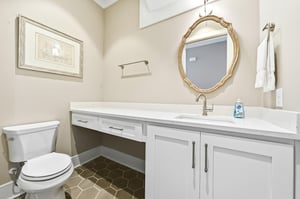 The half bath sits near the foyer and open gathering space for convenient daytime use.