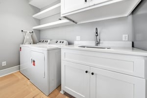 A washer, dryer, utility sink and cabinets make beach towels and everyday cleanup easier.