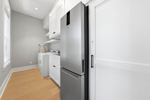 Extra cold storage beside the washer and dryer gives a full house more room for groceries and drinks.