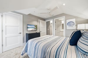 This angle shows the TV, dresser, hallway connection and full bath just outside the room.