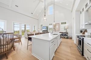 White beams span the kitchen, dining area and living room.