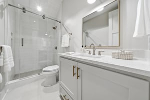A single vanity and goldtoned fixtures complete this bathroom.
