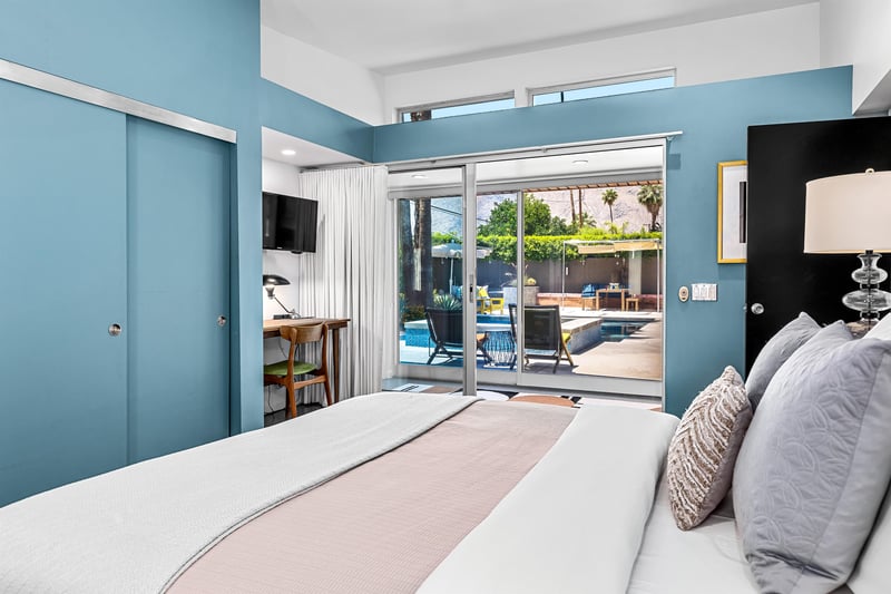 Primary bedroom with views of the backyard through sliding doors