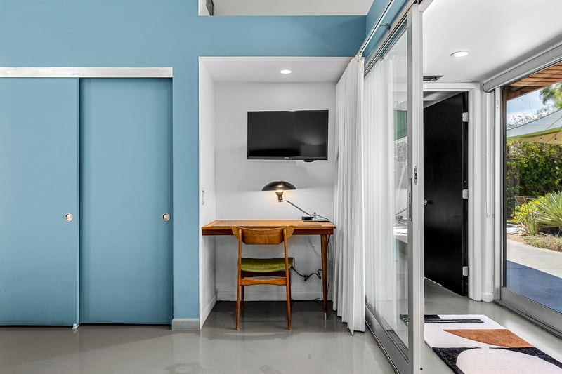 Built in desk in with TV mounted to wall above