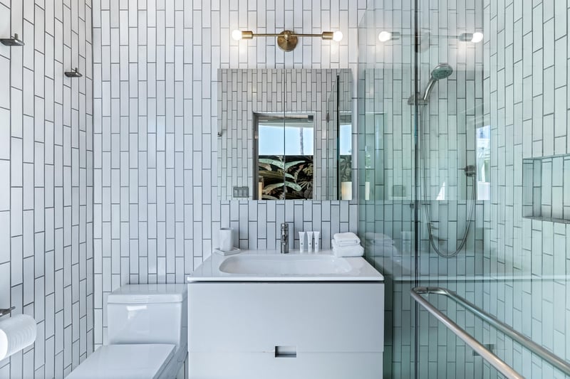 Sophisticated whitetiled ensuite bathroom