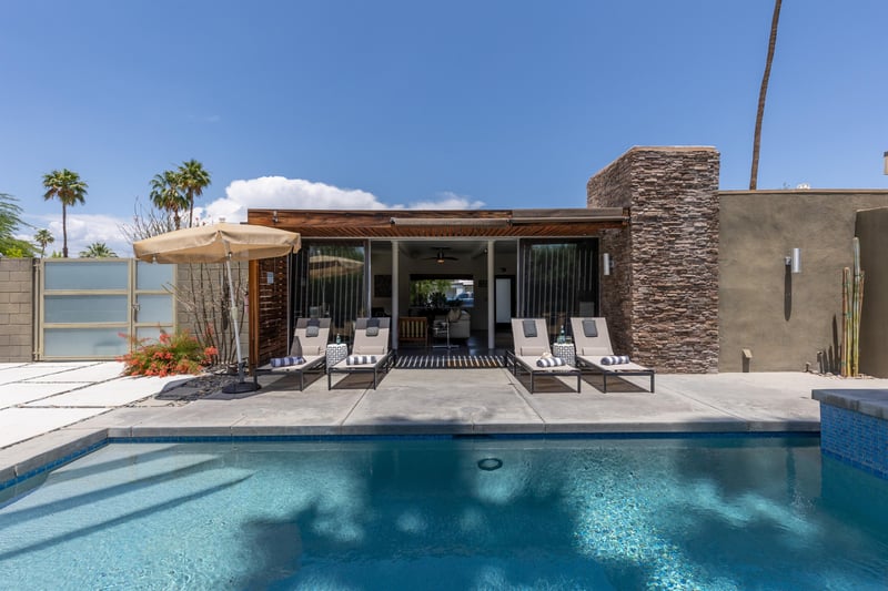 Loungers in front of glistening pool