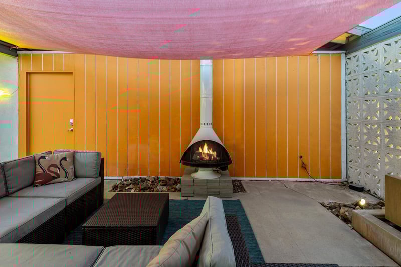 Covered outdoor lounge area with fireplace