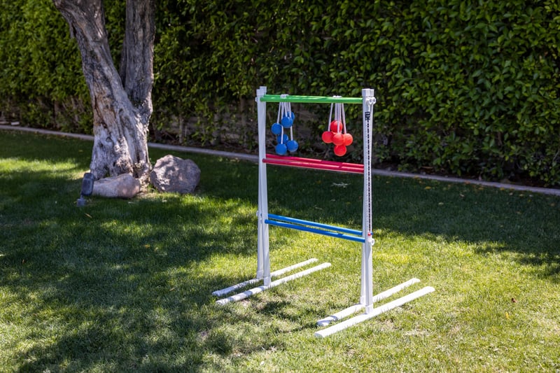 Play ladder toss on the green yard,