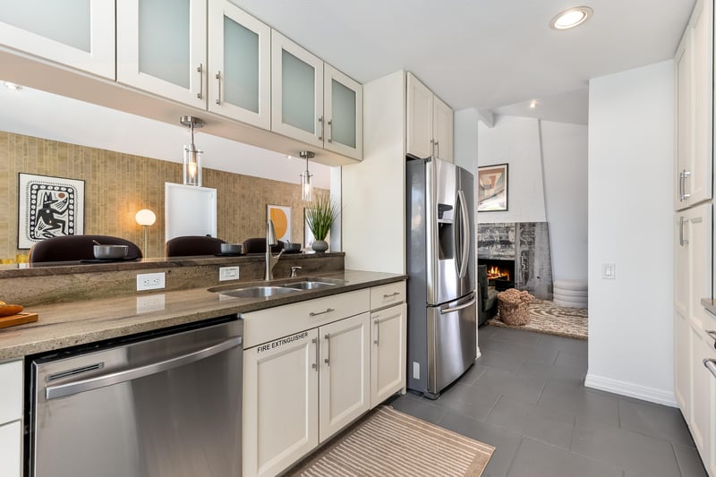 Lovely white cabinets host many culinary amenities