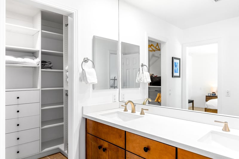 Primary en suite bath with large closet and double vanity sinks