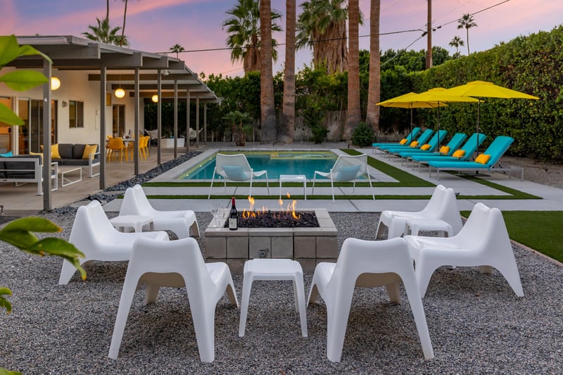 Gather around your private fire pit as sunset paints the sky, with the sparkling pool and modern retreat creating your perfect evening backdrop.