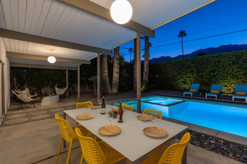 Dine al fresco under soft lighting while your private pool glows invitingly nearby, mountains creating a stunning backdrop for unforgettable evenings.