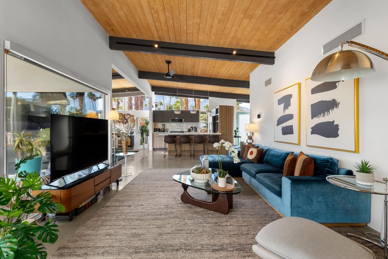 Relax in your stylish midcentury living room with soaring wood ceilings, designer furnishings, and seamless indooroutdoor flow.