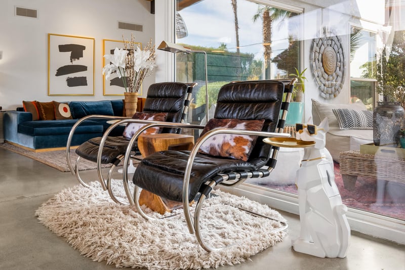 Sink into these luxurious leather chairs in your bright living space, where modern design meets comfort perfectly.