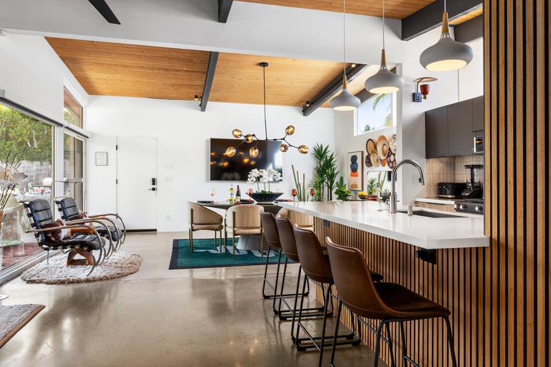 Gather around this stunning kitchen island where sleek design meets warm wood accents, creating your perfect space for morning coffee and evening conversations.