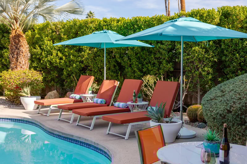 Sink into plush poolside loungers where turquoise umbrellas provide perfect shade for your afternoon retreat.