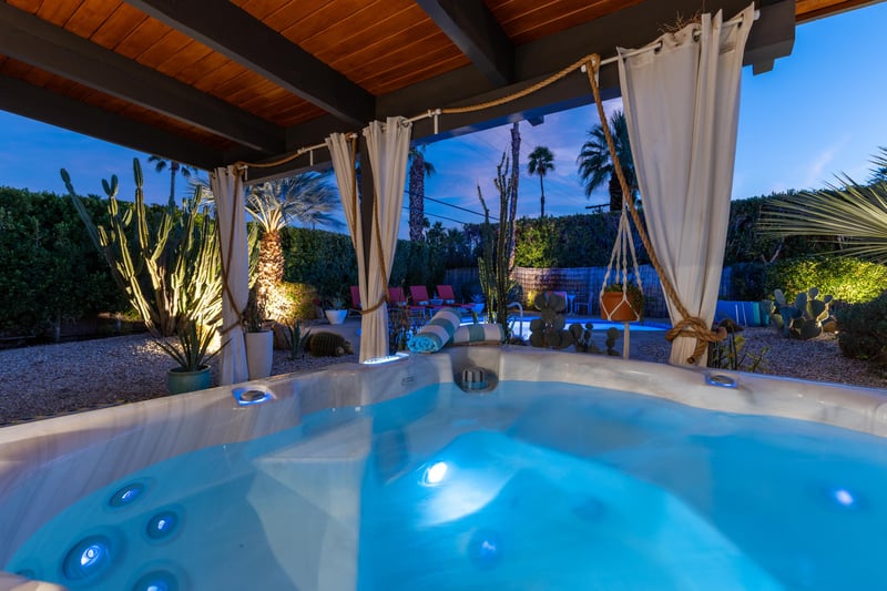 Soak under desert stars in your private hot tub sanctuary, where flowing curtains and glowing cacti create pure magic.