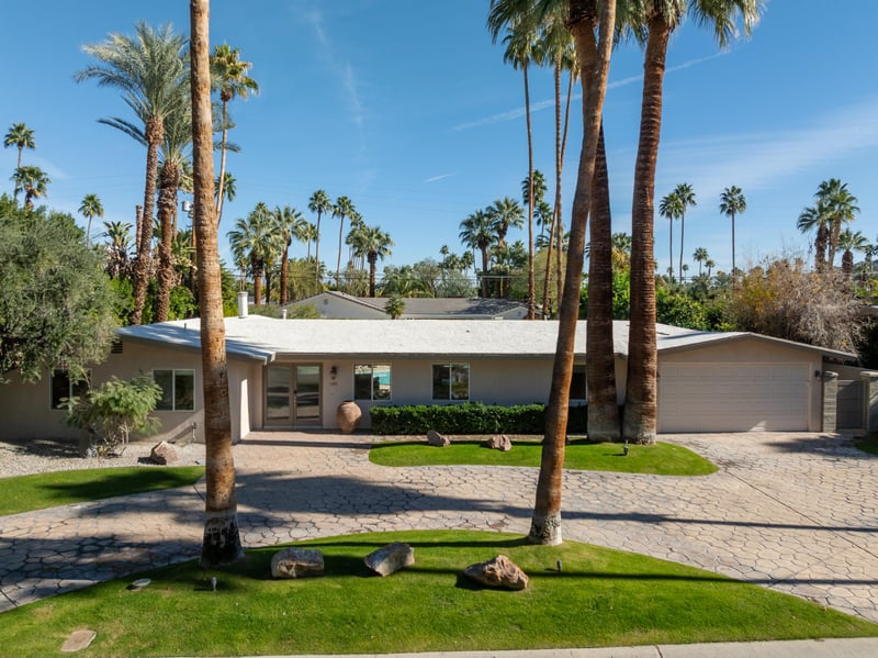 Manicured lawns and towering palm trees