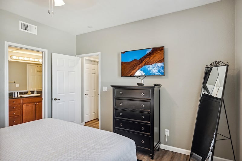 Second bedroom  dresser chest, standing mirror and 43 Smart TV
