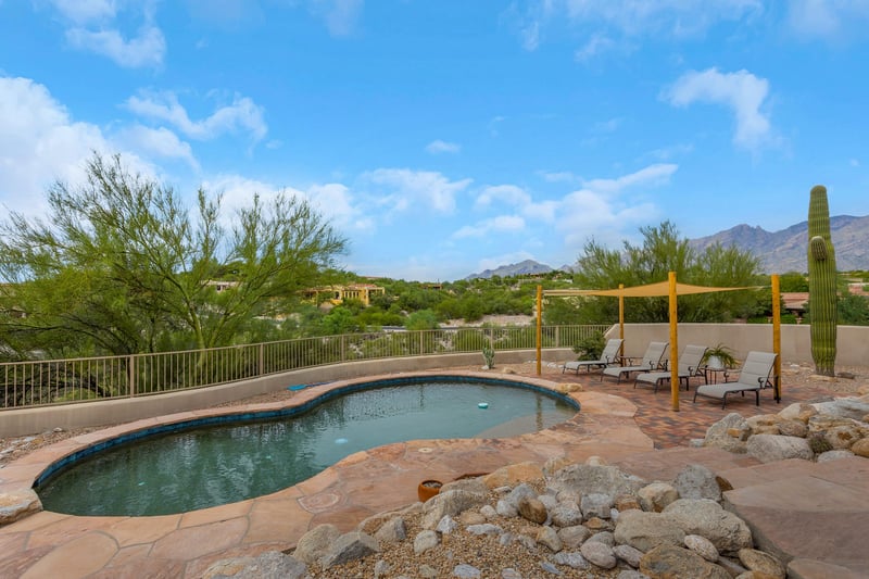 Pool with lounging chairs on the mountain side.